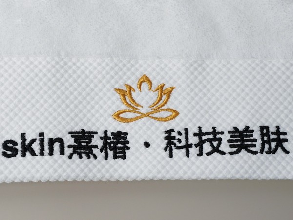 Pure cotton white towel with platinum segment embroidery in the beauty salon